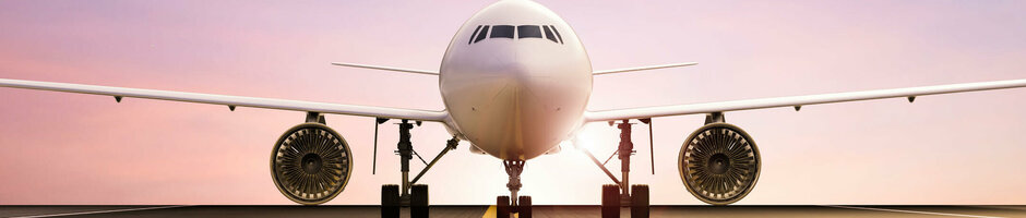 Airport tour in Bremen | Accompanying programme ATLANTIC Hotel Airport Bremen Front view of an airplane on the runway at sunset, symbolizing proximity to the airport.