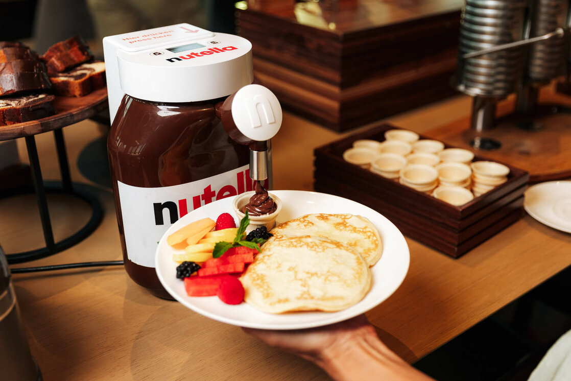 ATLANTIC Hotel Heidelberg Breakfast Nutella Pancakes Pancakes with fresh fruit and Nutella dispenser at the breakfast buffet in the ATLANTIC Hotel Heidelberg.