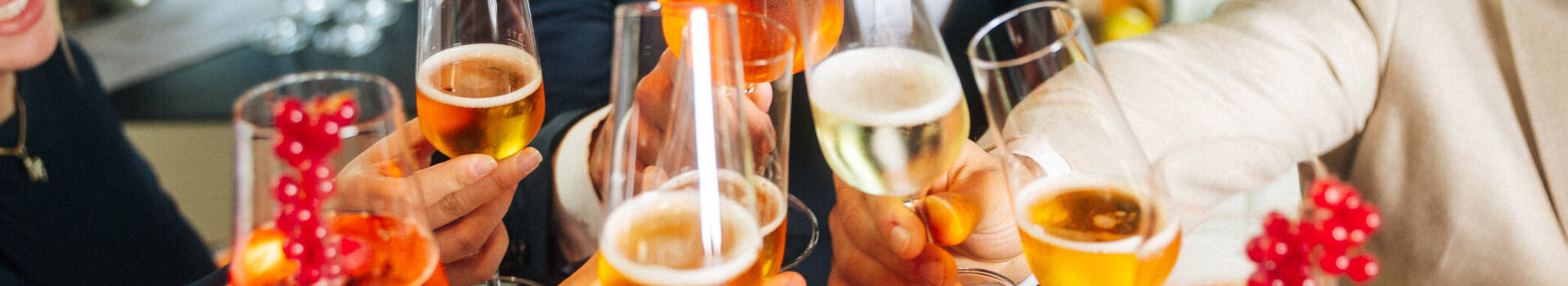 Menschen stoßen mit Sekt und Aperolgläsern an.