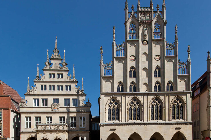Historic buildings on Prinzipalmarkt in Münster in sunny weather, with people and cafés in the foreground.
