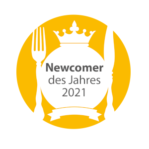 Logo with crown, fork and knife, text: "Newcomer of the Year 2021", yellow background.