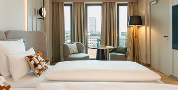 A view of the seating area and the Frankfurt skyline from the bed.