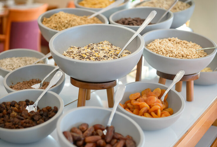 Various types of muesli and dried fruit at the breakfast buffet