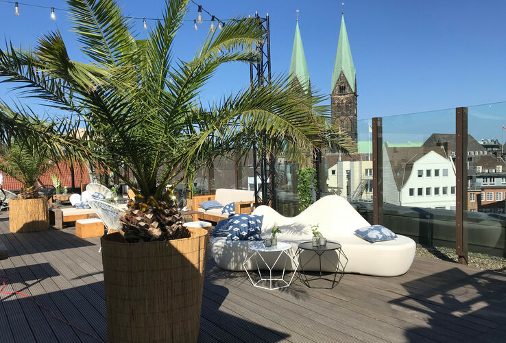 Roof terrace at the ATLANTIC Grand Hotel Bremen Roof terrace with palm trees, cozy seating and a view of Bremen's church towers at the ATLANTIC Grand Hotel Bremen.