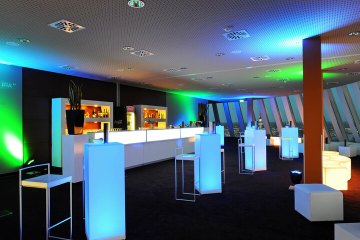 Celebrate in the Captain´s Lounge of the ATLANTIC Hotel Sail City Modern hotel bar with illuminated tables and colorful lights at the ATLANTIC Hotel Sail City, Bremerhaven.