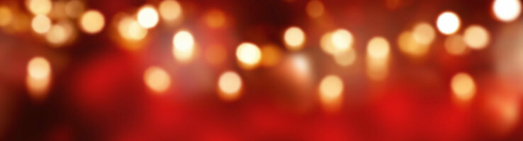 Wooden floor in front of a blurred, red-gold bokeh background in the ATLANTIC Grand Hotel Bremen.