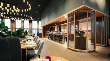 ATLANTIC Hotel Heidelberg Breakfast Modern restaurant in the ATLANTIC Hotel Heidelberg with elegant lighting, laid tables and a spacious buffet area.