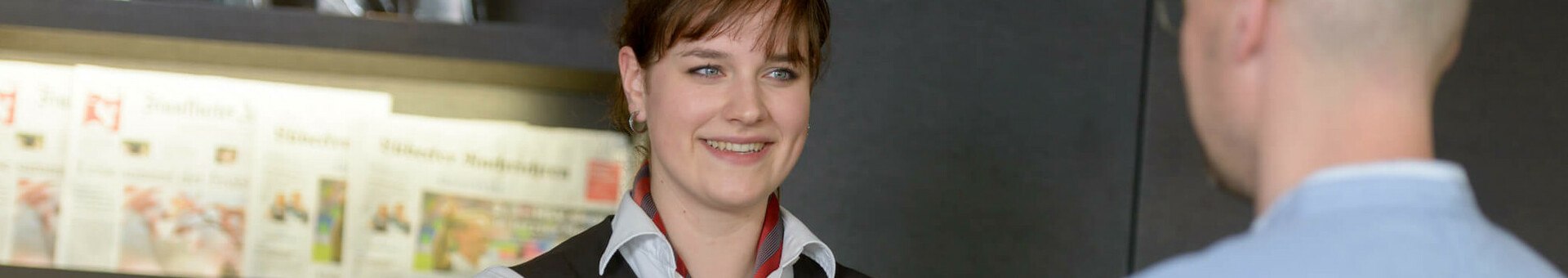 ATLANTIC Hotel Lübeck – Check in Receptionist at the ATLANTIC Hotel Lübeck hands a guest a room card at reception.