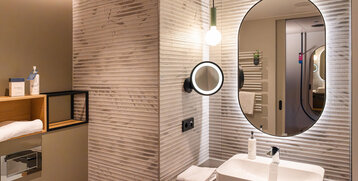 The mirror and washbasin in the bathroom.
