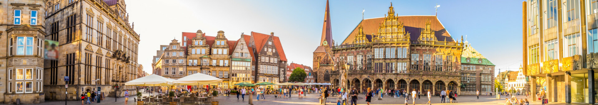 Historic market square in Bremen with town hall and lively atmosphere in the sunshine.