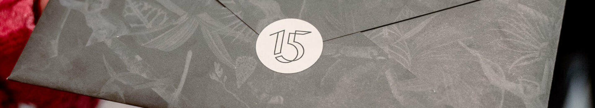 Hands holding an elegant envelope labeled "Experience Culinary Heights" at the ATLANTIC Hotel Heidelberg.