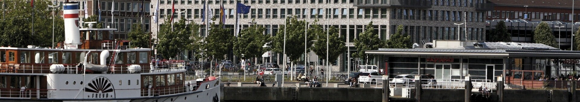 Directly at the Kiel Fjord - exterior view of the ATLANTIC Hotel Kiel at daytime