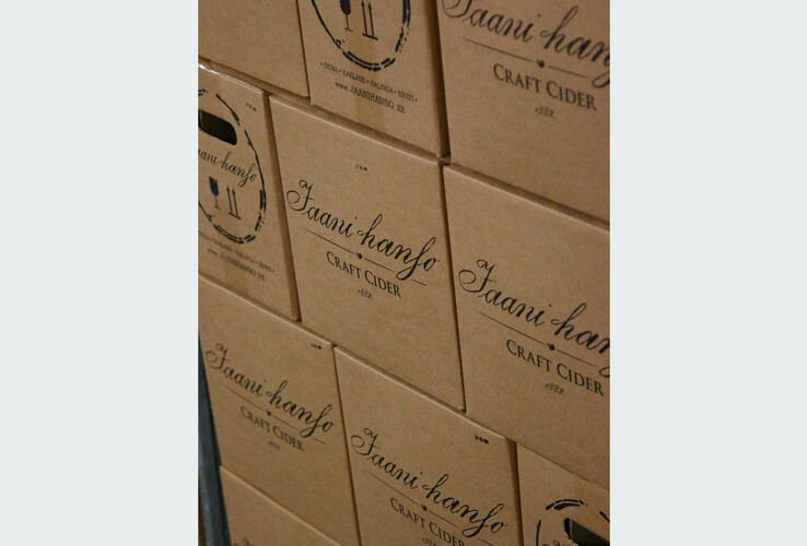 Stacked cartons with the inscription "Jaanihanso Craft Cider", brown packaging, black text.