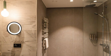 A large rain shower in the bathroom.
