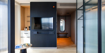 View from the seating area towards the coffee machine and the television.