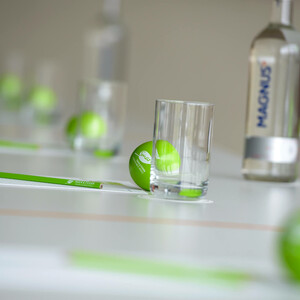 Meeting set-up at the ATLANTIC Hotels Conference table with green balls, glasses, pens and a water bottle, stylishly arranged.