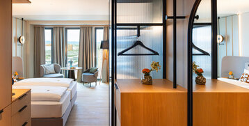A view of the room with modern furniture and wooden accents.