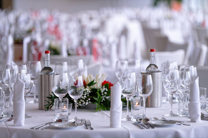 Elegantly laid table at the ATLANTIC Hotel, with glasses, cutlery and flower arrangements.
