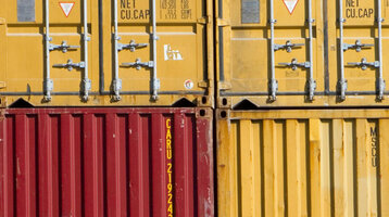 Stacked colorful shipping containers at the harbor symbolize the maritime atmosphere in Bremerhaven.