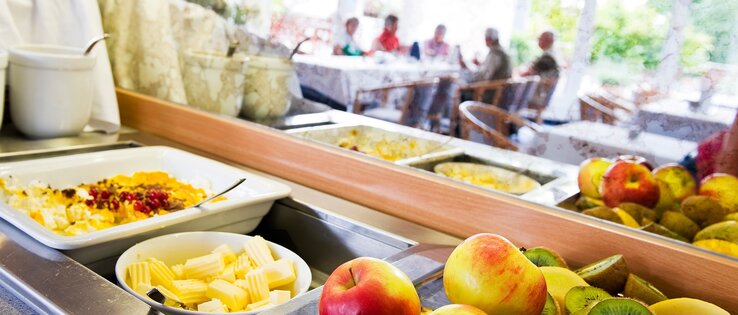 Breakfast buffet with a great selection in the ATLANTIC Hotel Vegesack in Bremen  Breakfast buffet with fresh fruit, cheese and muesli at the ATLANTIC Hotel Vegesack, Bremen. Guests at the table in the background.