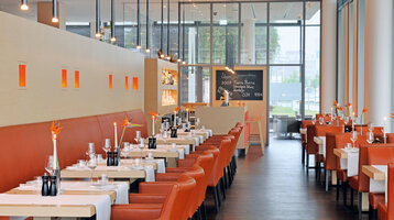 The Pier 16 restaurant with tables laid for dining.