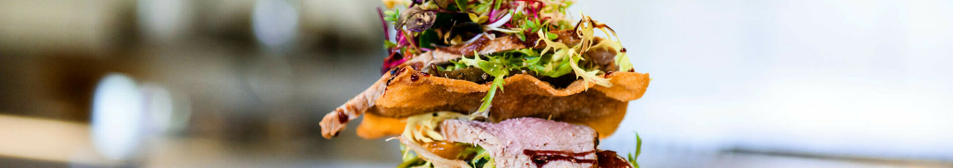 Vorspeise: Teriyaki vom Rind | Restaurant CAMPUS im ATLANTIC Hotel Universum Elegantes Gericht mit Fleisch, knusprigen Schichten und frischen Kräutern auf einem Teller im ATLANTIC Hotel Universum.