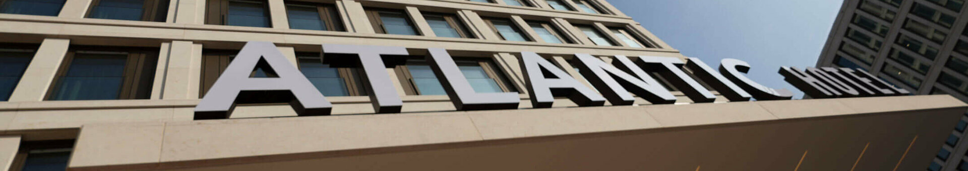 Facade of the ATLANTIC Hotel Heidelberg with blue sky in the background.