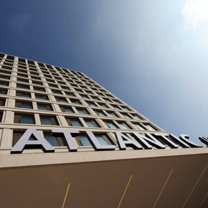 Facade of the ATLANTIC Hotel Heidelberg with blue sky in the background.